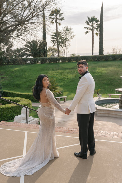 Bride and groom posing in front of the camera.