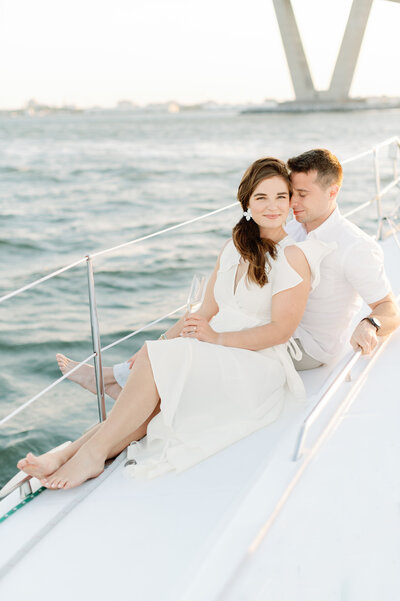 couple sitting on a sailboat in the charleston harbor