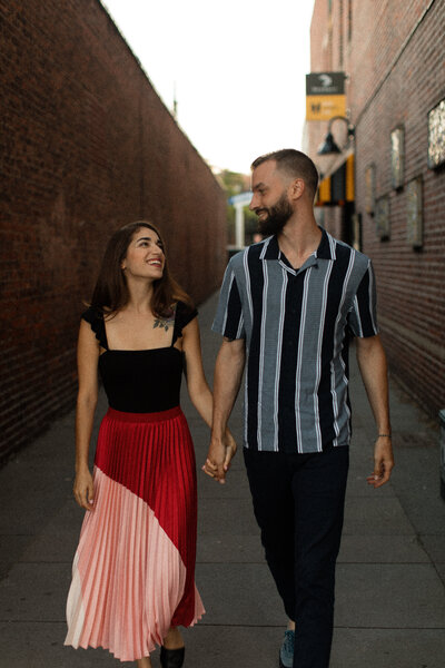 Man and woman walking and holding hands