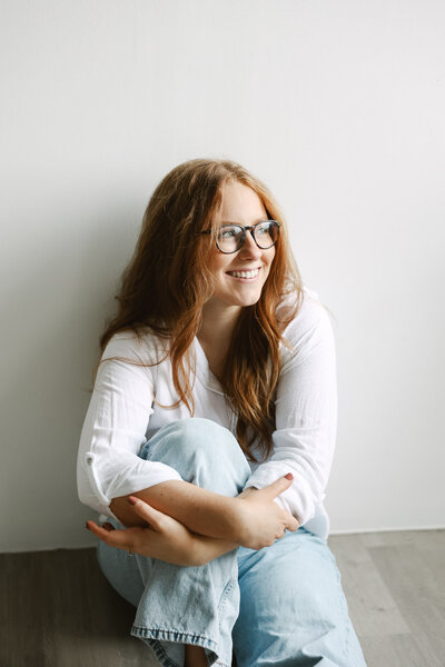 Image of Riverstone founder smiling to the side while sitting