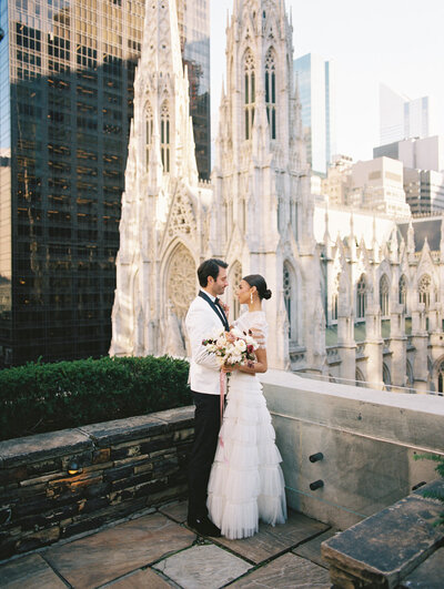 Bride and groom embracing 620 Loft & Garden rooftop wedding venue in NYC