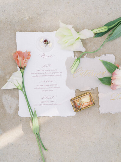 Wedding invitation flat lay decorated with long stemmed flowers