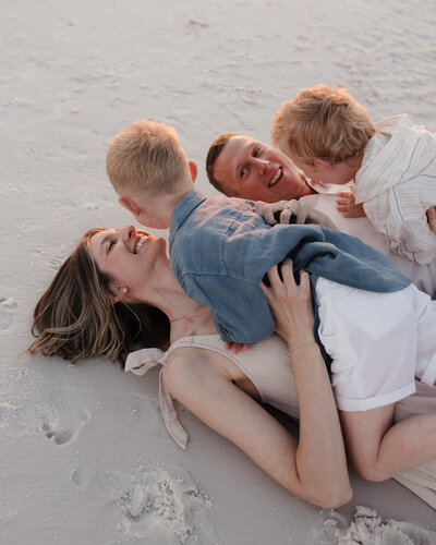 young family plays on the beach