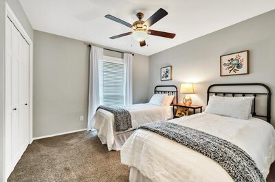 Guest room with two twin beds in this Entry way of this three-bedroom, two-bathroom vacation rental home featured on Chip and Joanna Gaines' Fixer Upper located in downtown Waco, TX.