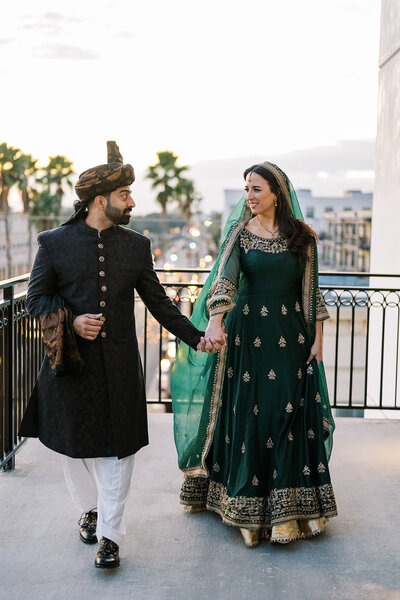 bride and groom embracing while bride holds colorful bouquet
