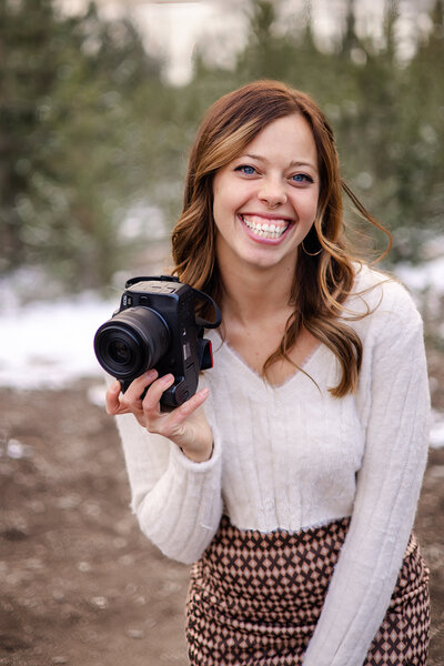 Photographer in Beige Shirt with Camera in Hand