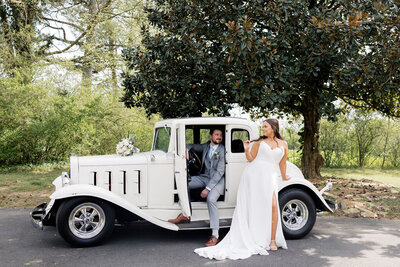 Bride and groom posing near vintage car on their wedding day in Alabama — Madison Abernathy Photo