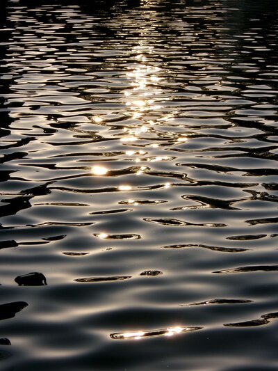 ocean surface with sunlight reflecting, evoking serenity, beauty, and heartfelt moments at Love Light Wellness Kauai