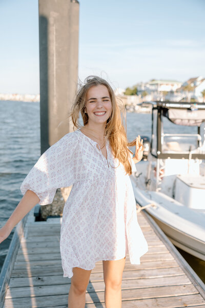 Senior portraits taken while twirling around on a dock