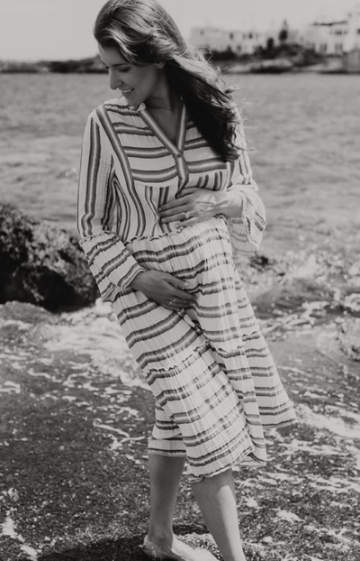 A pregnant women posing for a photo in Greece 