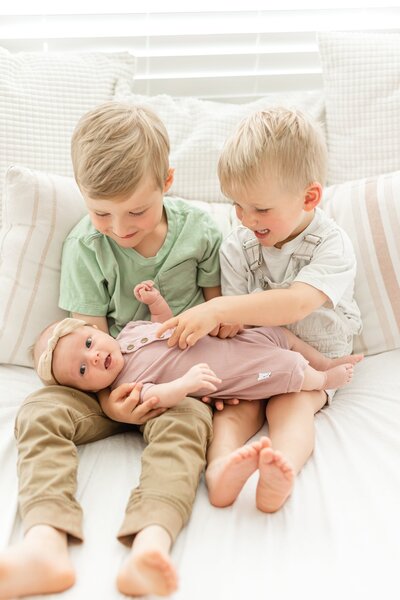 a mom sitting with her kids in a lavender field