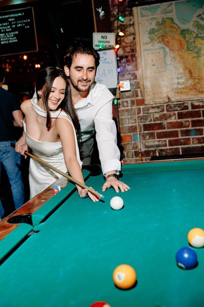 couple playing pool at a bar in los angeles
