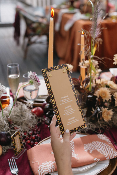 Custom wedding menu with gold and black patterned border designed by Cove Mill Design Co. for an elegant New England reception.