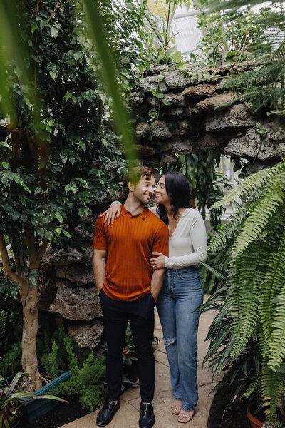 Photos of a couple in a greenhouse