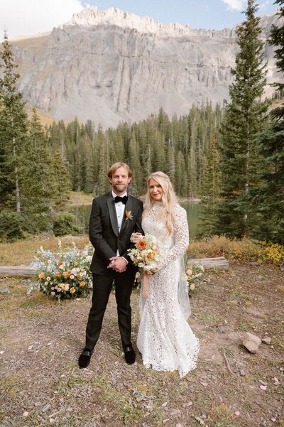 A couple poses in the forest for their Durango wedding portraits