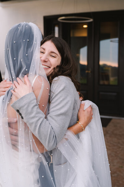 wedding planner Sarah hugging bride after wedding ceremony
