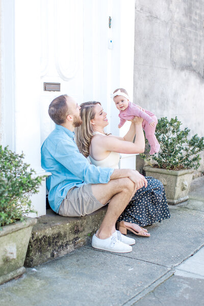 Young husband and wife play with baby in Charleston, South  Carolina.