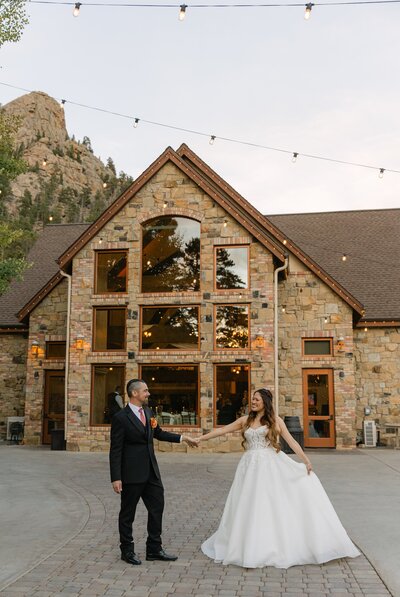 Bride and groom dancing outdoors on the terrace at Della Terra Mountain Chateau 