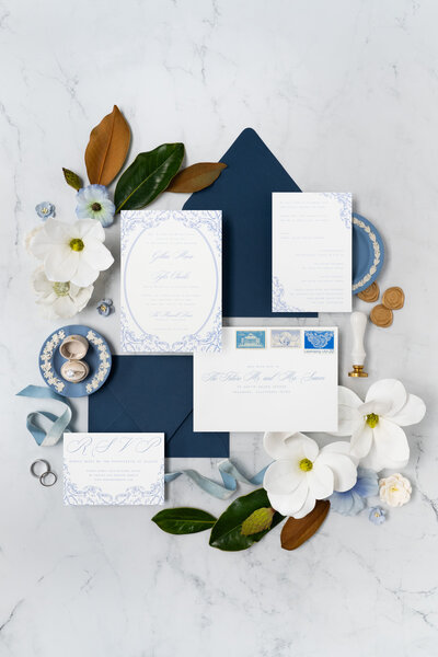 Formal, traditional wedding invitation suite with vintage frame, blue envelopes, vintage postage, and gold wax seals