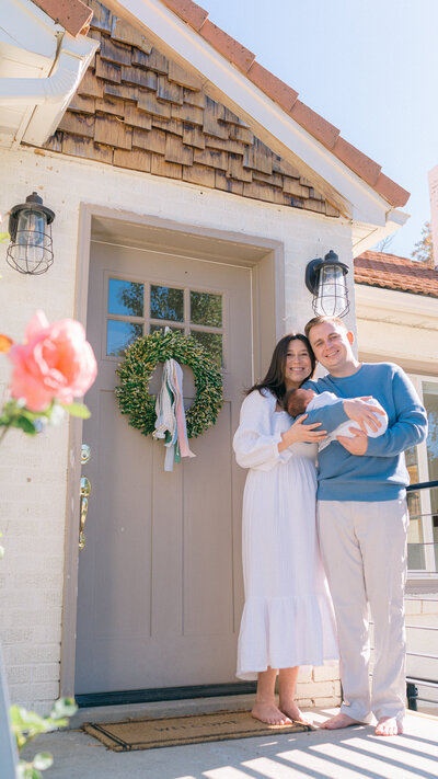 family holding baby at home