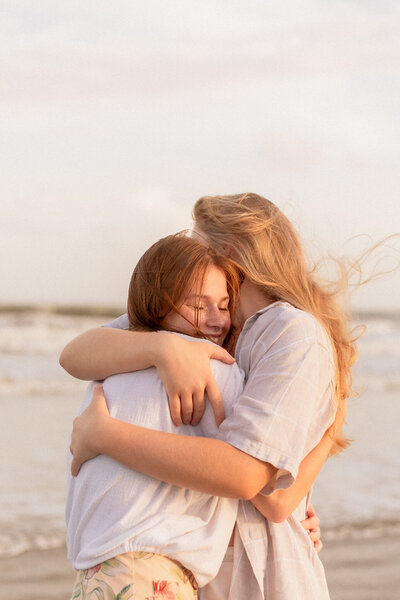 Photograph of couple embracing  at Folly Beach outside of Charleston