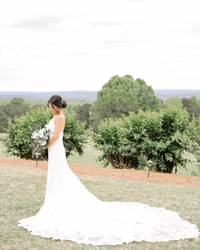 Bride poses while holding bouquet