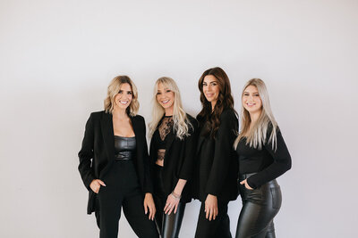 Team photo of wedding planners in black outfits.