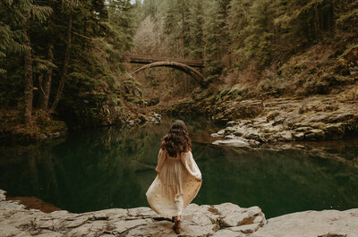 girl standing in river in washington nature park
