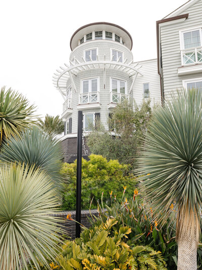 Tropical landscape surrounding the round tower exterior of Lido House in Newport Beach