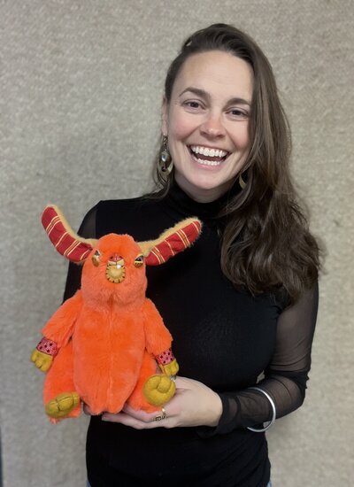 Natalie holding handcrafted stuffed toy