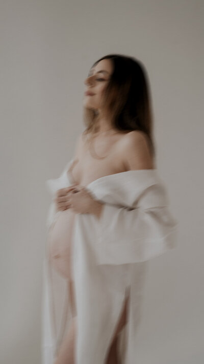 a pregnant woman wearing a white kimono
