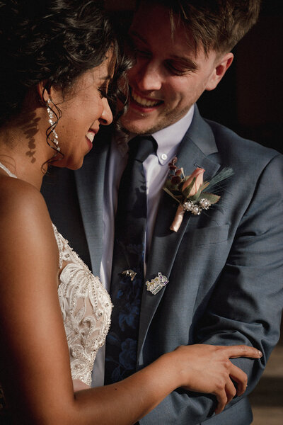 smiling couple kissing hand in sunlight