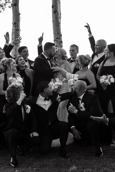 The bride turns up the fun at her after-party, sipping a drink in a playful cowboy hat—where wedding day elegance meets late-night revelry.