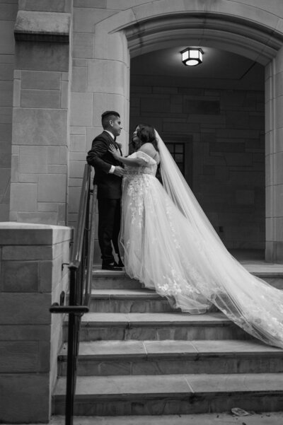 Bride, and groom, sitting on a green velvet sofa