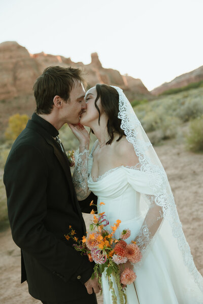 Bride and groom kiss in the aisle after their mountain wedding ceremony