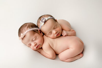 Twin girls snuggling together. Natural, minimalistic, fresno newborn photographer