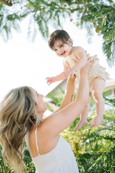 happy child and mother against a lush green background on a bright sunny day