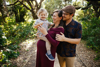 Family of Three with a Pregnant Mom posing for Family Portraits