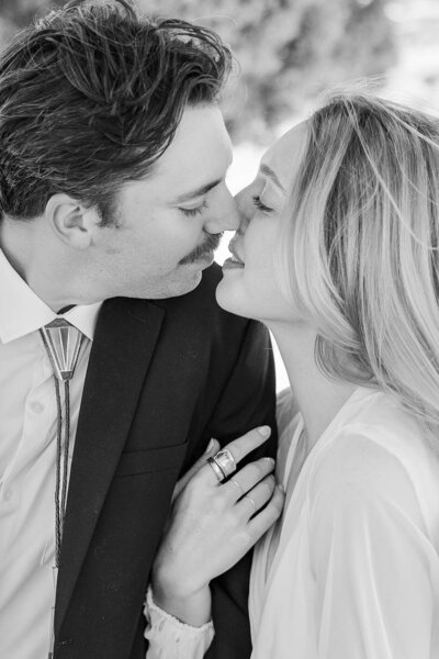 Intimate moment of a bride and groom sharing almost kissing during their elopement at the breathtaking Little Sahara Sand Dunes in Utah.