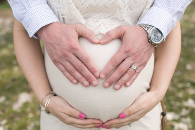 Husband holding wife's baby bump during a Maternity photoshoot
