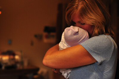 woman kissing new granndson