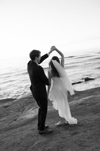 Bride and groom sharing their first dance by a picturesque lake in Wisconsin, captured by a Wisconsin wedding photographer.