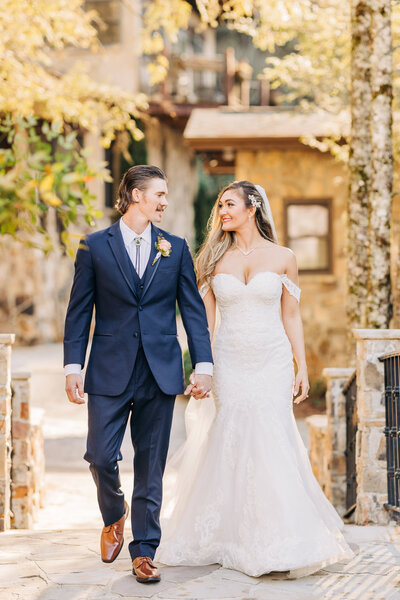 Bride and groom cross bridge at Chota Falls with the stone architecture looks like your in Italy. Photo taken by Chicago + Atlanta Photographer Ella Grace Richards of Forever Love Photography 