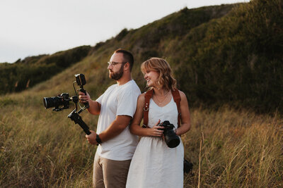 Alex and Anna Williams, creators of Williams Photo and Film looking into a cinema camera