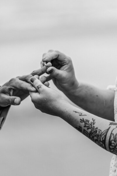 during their Oregon coast elopement, a couple exchanges rings.