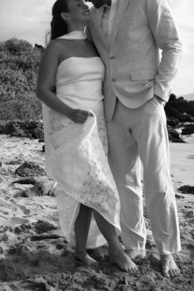 bride and groom on beach together in hawaii
