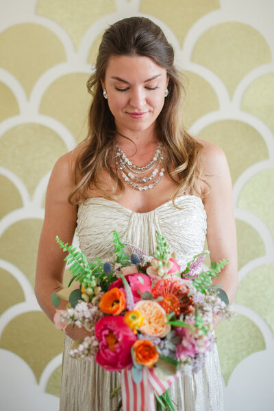 mixed race bride with colorful hair and makeup in a white dress for her wedding day in  San Jose, CA