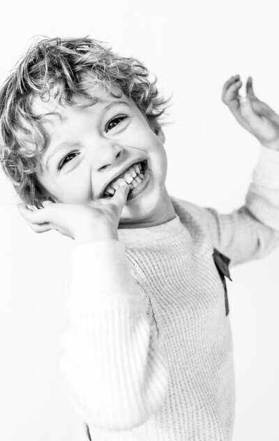 Side angle of happy boy looking at St. Petersburg photographer