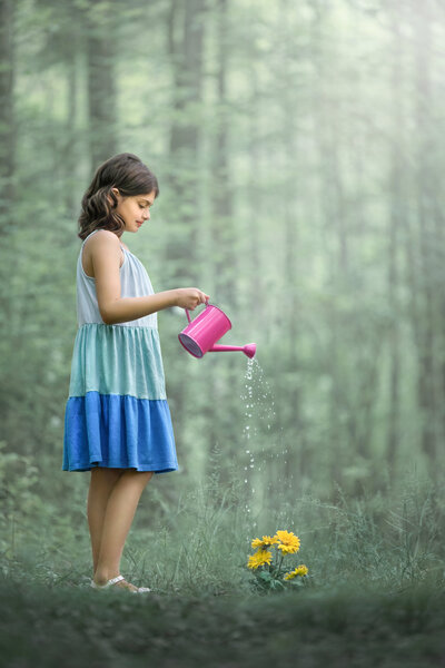 child watering flower for fine art portrait at Veterans park in hamilton, New Jersey.