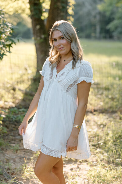 Girl smiles at the camera and twirls her dress